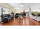 Open living space with wood floors, connecting living room, dining area and kitchen at 3813 Blue Dasher Dr, Kissimmee, FL 34744