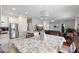 Bright kitchen and open-concept dining and living space, and stainless steel refrigerator at 3813 Blue Dasher Dr, Kissimmee, FL 34744