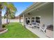 Back patio featuring an outdoor seating area, a fan and a lush green lawn at 3813 Blue Dasher Dr, Kissimmee, FL 34744