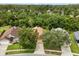 Aerial view of the house with mature trees enhancing the home's curb appeal at 4110 Boca Woods Dr, Orlando, FL 32826