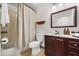 Small bathroom with vanity, mirror, toilet, and tiled shower at 4110 Boca Woods Dr, Orlando, FL 32826