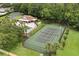 Overhead image showing the community tennis court, pool, and clubhouse amidst mature trees at 4110 Boca Woods Dr, Orlando, FL 32826