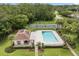 Aerial view showcasing the community pool, tennis courts, and clubhouse surrounded by lush landscaping at 4110 Boca Woods Dr, Orlando, FL 32826