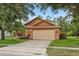 Charming single-story home with a two-car garage and well-maintained landscaping at 4110 Boca Woods Dr, Orlando, FL 32826