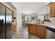 Open-concept kitchen and dining area featuring wood cabinets, stainless appliances, and lots of natural light at 4110 Boca Woods Dr, Orlando, FL 32826