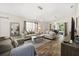 Spacious living room with stylish furniture, wood flooring, and bright windows at 4110 Boca Woods Dr, Orlando, FL 32826