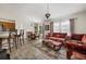 Open living space with wood-look flooring, eclectic furnishings, and lots of light at 4110 Boca Woods Dr, Orlando, FL 32826