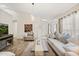 Comfortable living room with wood floors, neutral tones, and ample natural light at 4110 Boca Woods Dr, Orlando, FL 32826