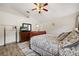 Cozy bedroom with wood-look flooring, ceiling fan, and a large dresser with TV at 4110 Boca Woods Dr, Orlando, FL 32826