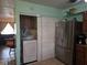 Kitchen with stainless steel refrigerator and laundry closet at 4123 Gander Ave, Orlando, FL 32822