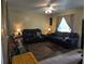 Cozy living room with comfortable sofas, tile and wood flooring and a ceiling fan at 4123 Gander Ave, Orlando, FL 32822