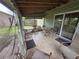 This cozy screened porch has tile flooring, outdoor seating and backyard views from all sides at 4123 Gander Ave, Orlando, FL 32822