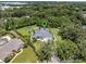Serene aerial view showcasing the home nestled amongst mature trees and lush landscaping with an in-ground pool at 4454 Aspenwood Ct, Orlando, FL 32835
