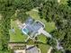 Luxurious home with a screened pool, surrounded by lush landscaping and mature trees at 4454 Aspenwood Ct, Orlando, FL 32835