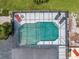 Aerial view showcases the sparkling pool with screened enclosure and outdoor lounge area in the private backyard at 4454 Aspenwood Ct, Orlando, FL 32835
