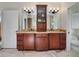 Bathroom showcasing an impressive double vanity with granite countertop and decorative lighting fixtures at 4454 Aspenwood Ct, Orlando, FL 32835