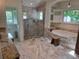 Luxurious bathroom with a glass-enclosed shower, soaking tub, and elegant marble countertops at 4454 Aspenwood Ct, Orlando, FL 32835