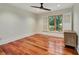 Bedroom featuring hardwood floors and bright windows fitted with wood shutters at 4454 Aspenwood Ct, Orlando, FL 32835