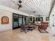 Relaxing covered patio featuring comfortable seating and tiled floors, perfect for enjoying the outdoor view at 4454 Aspenwood Ct, Orlando, FL 32835