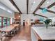 Open concept kitchen and dining room with hardwood floors and beam ceiling at 4454 Aspenwood Ct, Orlando, FL 32835