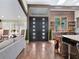 Grand entryway with modern black doors, wood accents, and gleaming hardwood floors at 4454 Aspenwood Ct, Orlando, FL 32835