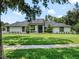 Charming exterior elevation of the residence featuring a lush green lawn and meticulous landscaping at 4454 Aspenwood Ct, Orlando, FL 32835