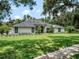 Stunning single-story home featuring a modern black and white design and lush green lawn at 4454 Aspenwood Ct, Orlando, FL 32835