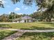 Well-maintained home with lush lawn and mature trees, offering privacy and curb appeal at 4454 Aspenwood Ct, Orlando, FL 32835