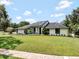 Beautiful single-story home with modern design, lush lawn, and mature landscaping at 4454 Aspenwood Ct, Orlando, FL 32835