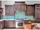 Well-appointed kitchen with backsplash, stainless steel appliances, and custom cabinetry at 4454 Aspenwood Ct, Orlando, FL 32835
