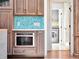 Kitchen cabinet with microwave and blue tile backsplash at 4454 Aspenwood Ct, Orlando, FL 32835