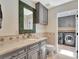 Bathroom with stylish gray vanity and decorative mirror and access to adjacent laundry room at 4454 Aspenwood Ct, Orlando, FL 32835