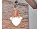 Unique copper and white glass pendant light fixture against a brick wall at 4454 Aspenwood Ct, Orlando, FL 32835