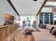 Comfortable living room with beam ceilings, large windows, and a stylish sectional sofa at 4454 Aspenwood Ct, Orlando, FL 32835