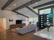 Bright living room featuring hardwood floors, high ceilings with wooden beams, and stylish contemporary decor at 4454 Aspenwood Ct, Orlando, FL 32835