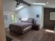 Bright main bedroom featuring hardwood floors, high ceilings with wooden beams, and skylights at 4454 Aspenwood Ct, Orlando, FL 32835