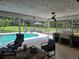 Inviting screened-in pool and grilling area with comfortable lounge chairs, perfect for relaxing outdoors in a private setting at 4454 Aspenwood Ct, Orlando, FL 32835