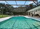 Sparkling pool with a screened lanai, seamlessly connects indoor and outdoor spaces for relaxation and entertainment at 4454 Aspenwood Ct, Orlando, FL 32835
