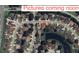 Aerial view of a residential neighborhood with tree-lined streets and a small pond at 451 Acacia Tree Way, Kissimmee, FL 34758