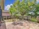 Private backyard with mature trees and a brick patio at 451 Acacia Tree Way, Kissimmee, FL 34758