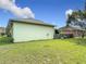 Exterior view of fenced backyard with green grass and shrubbery at 451 Acacia Tree Way, Kissimmee, FL 34758