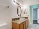 Bathroom boasts a round vessel sink on a granite countertop with mosaic tile backsplash at 451 Acacia Tree Way, Kissimmee, FL 34758