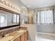 Modern bathroom featuring double sinks, a granite countertop, and glass enclosed shower at 451 Acacia Tree Way, Kissimmee, FL 34758