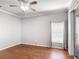 Bedroom with wood floors, ceiling fan, and sliding glass doors for natural light at 451 Acacia Tree Way, Kissimmee, FL 34758
