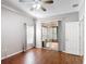 Bedroom featuring wood floors, ceiling fan, and access to a screened-in porch at 451 Acacia Tree Way, Kissimmee, FL 34758