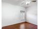 Cozy bedroom featuring hardwood floors and a large window at 451 Acacia Tree Way, Kissimmee, FL 34758