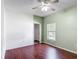Bedroom featuring hardwood floors, natural light, and walk-in closet at 451 Acacia Tree Way, Kissimmee, FL 34758