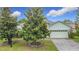 Well-maintained home exterior with mature trees enhancing curb appeal at 451 Acacia Tree Way, Kissimmee, FL 34758