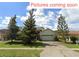 Charming one-story home with a two-car garage, mature trees, and well-maintained lawn at 451 Acacia Tree Way, Kissimmee, FL 34758
