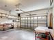 Spacious garage with overhead door, storage shelves and work bench at 451 Acacia Tree Way, Kissimmee, FL 34758